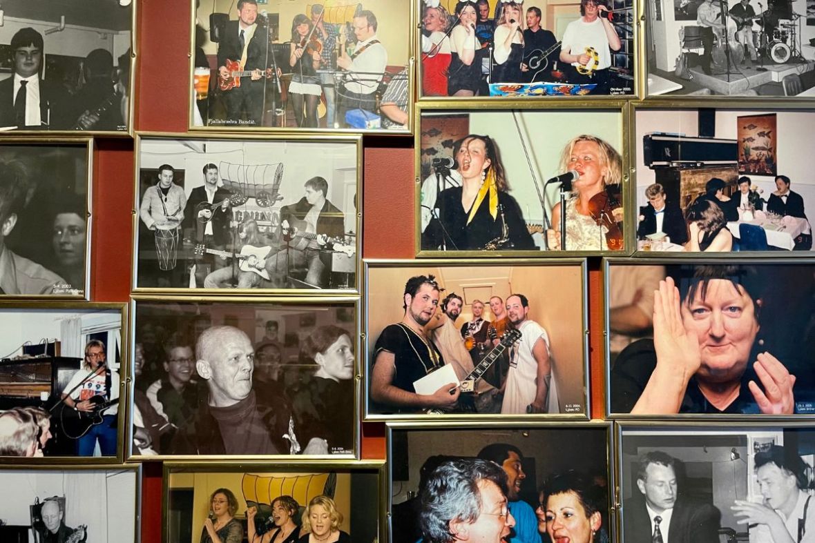 A wall of framed black-and-white photos showcasing live music history at Vagninn in Flateyri.