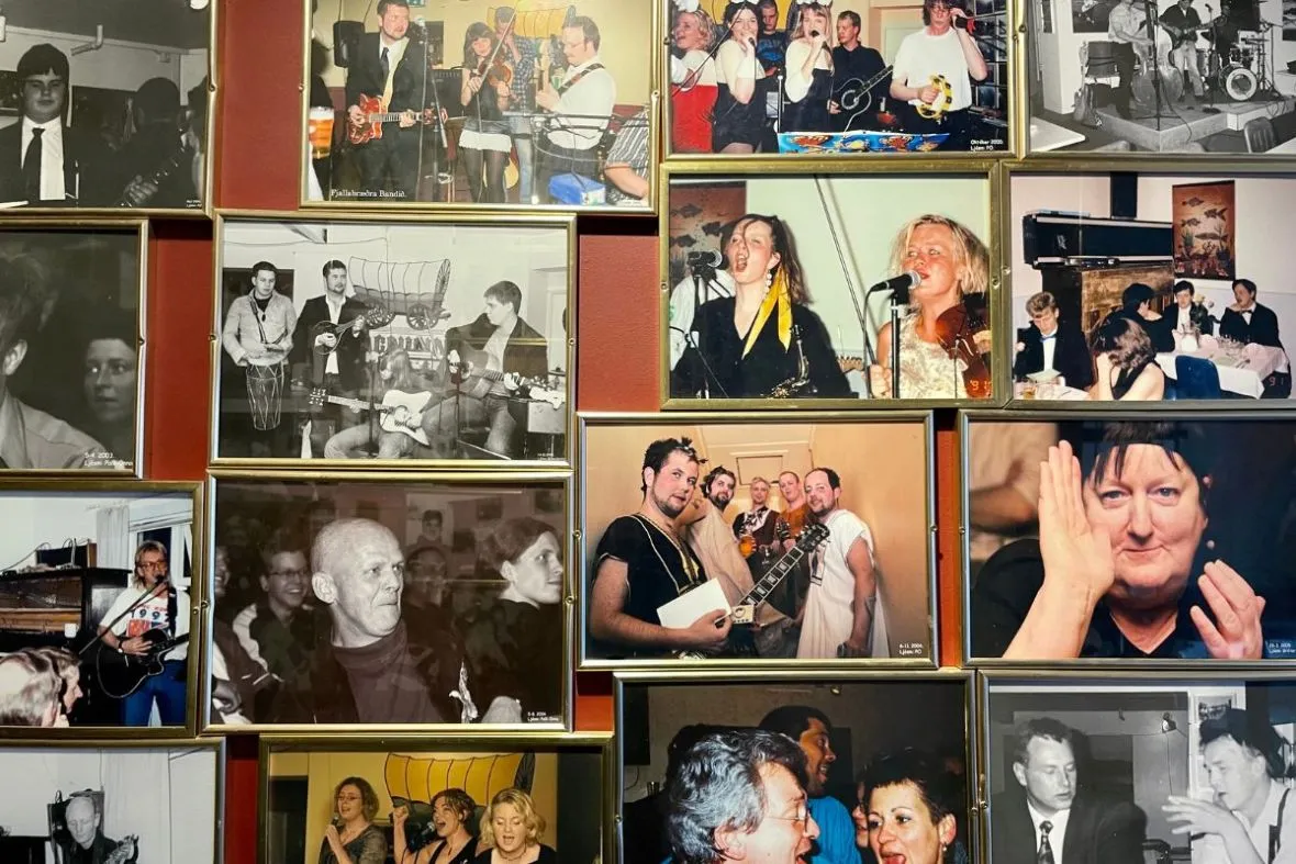 A wall of framed black-and-white photos showcasing live music history at Vagninn in Flateyri.