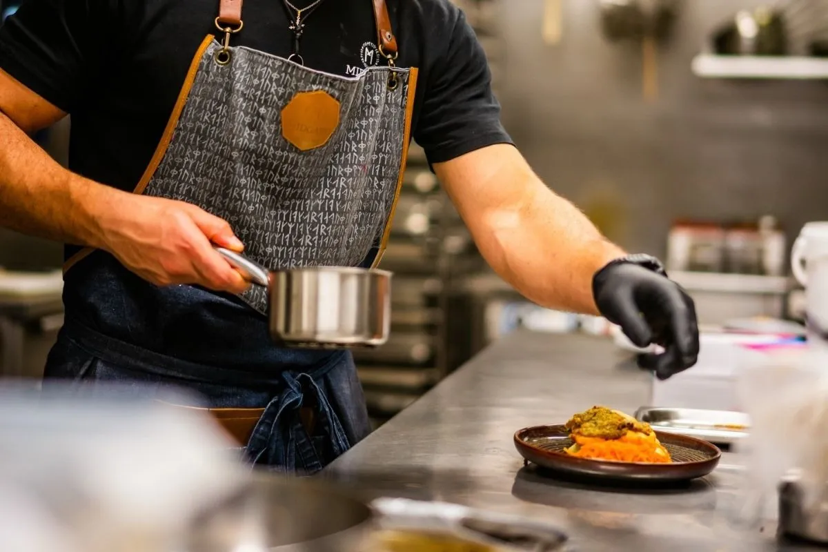 Professional kitchen staff at Midgard Restaurant preparing local Icelandic dishes in Hvolsvöllur.
