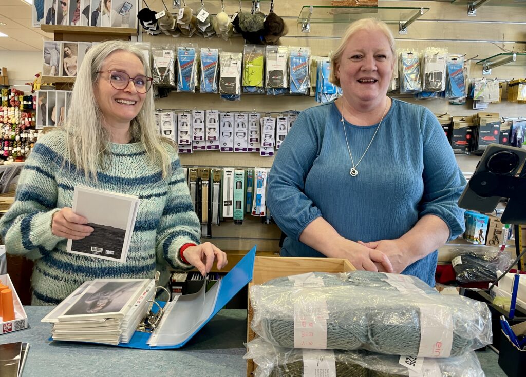 Hildur and a colleague at the counter at the handknitting association.