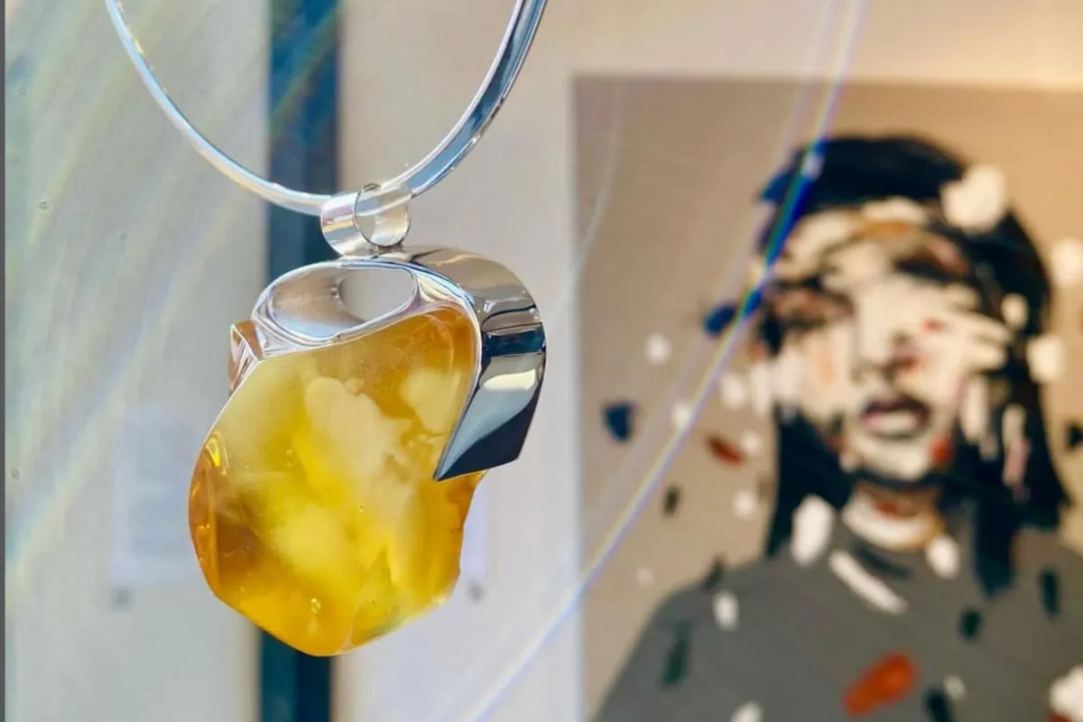 Large amber pendant necklace on display at the gallery.