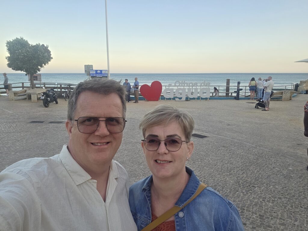 Einar Geirsson and his wife posing together by the seaside