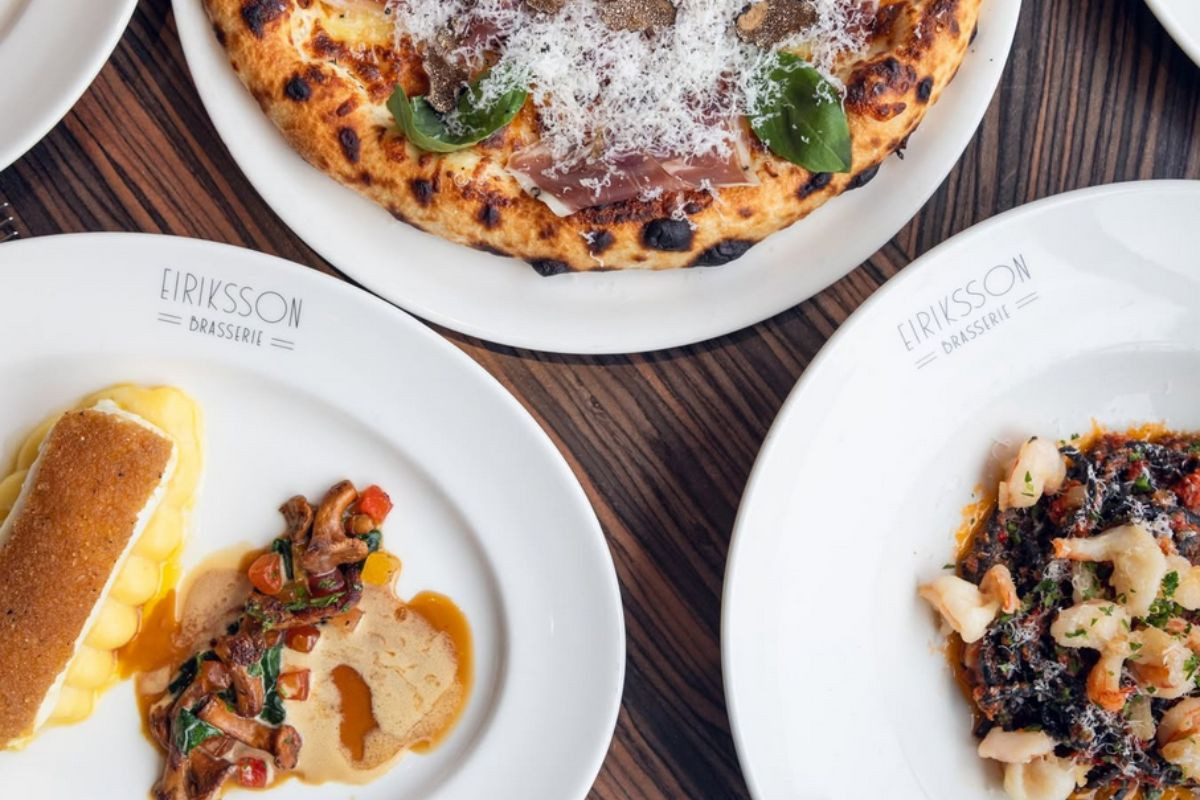 Italian dishes, including a gourmet pizza with prosciutto and truffle, a seafood entree, and pasta.