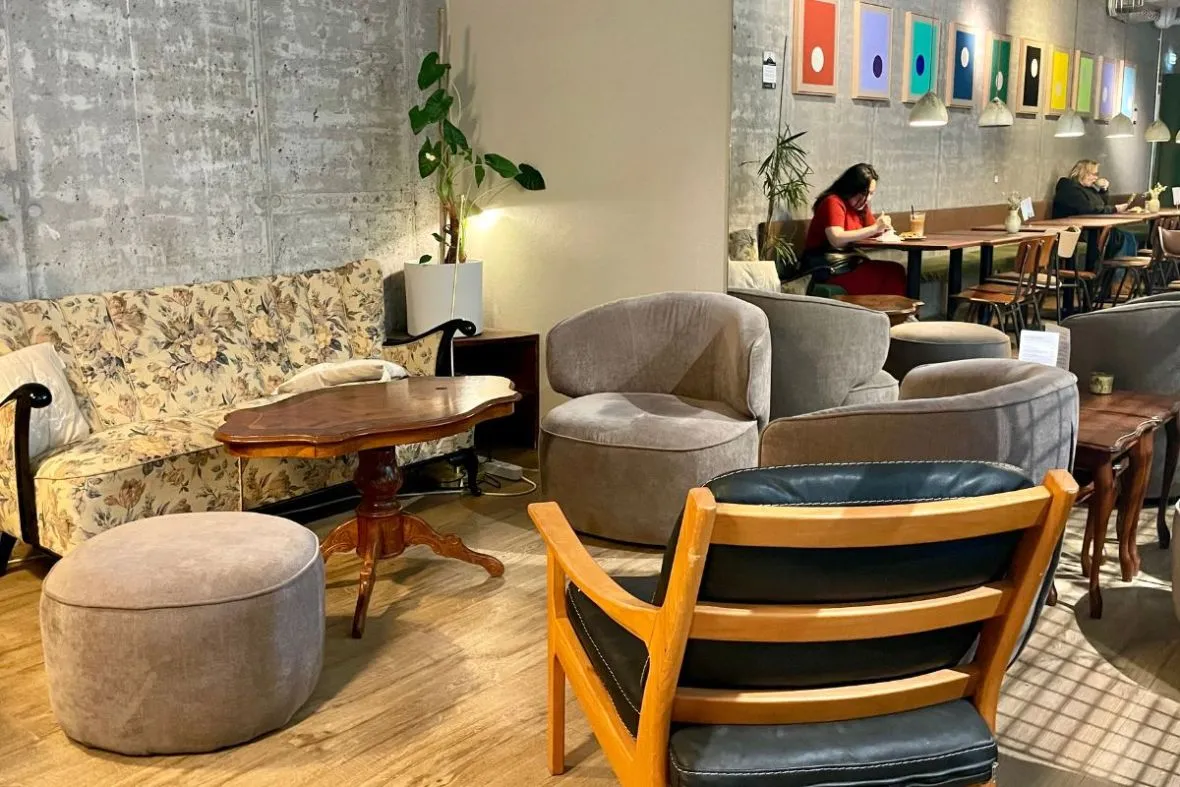 Comfortable lounge chairs and eclectic decor at Hygge Café & Micro Bakery - Barónsstígur.
