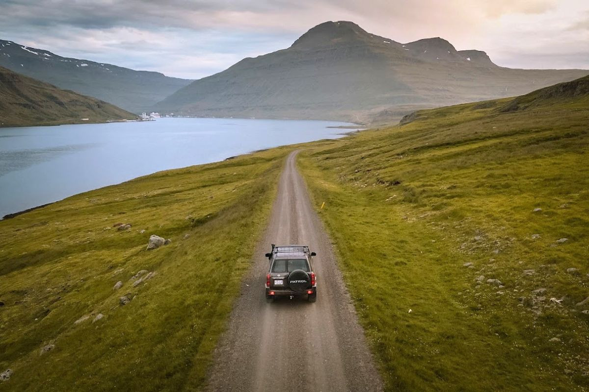 Eastfjords Adventure 4x4 tour driving along a scenic fjord in East Iceland.
