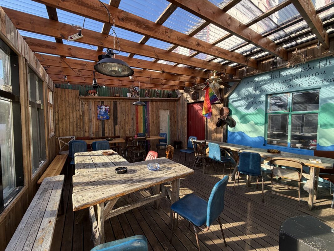 Rustic wooden sunroom indoor patio at Vagninn- Pub& Bistro in Flateyri West Iceland, recommended by Handpicked Iceland.