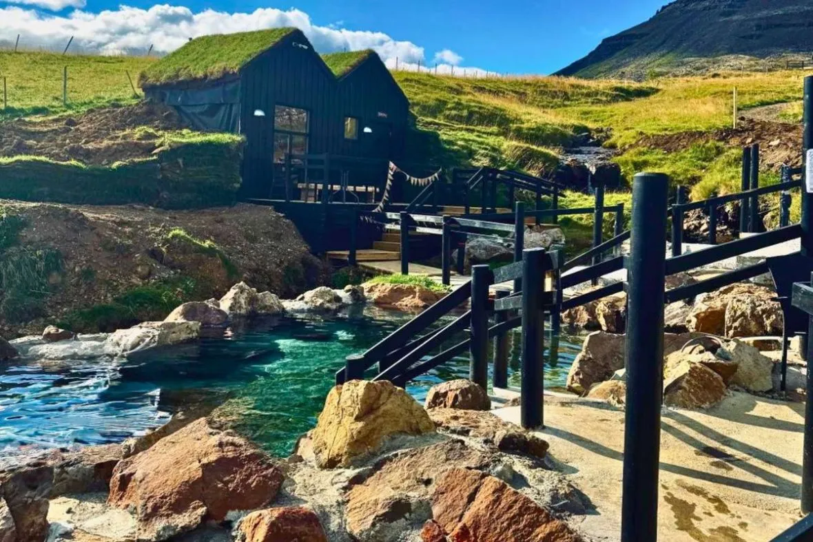 Relaxing geothermal pools and turf-roofed bathhouse at Hraunsnef Nature Baths in Borgarnes, West Iceland.