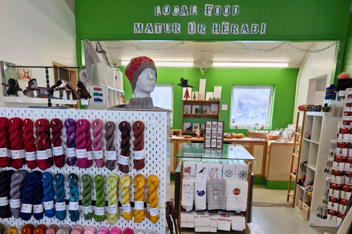 Colorful yarn skeins and local crafts on display inside Ljómalind Local Market.