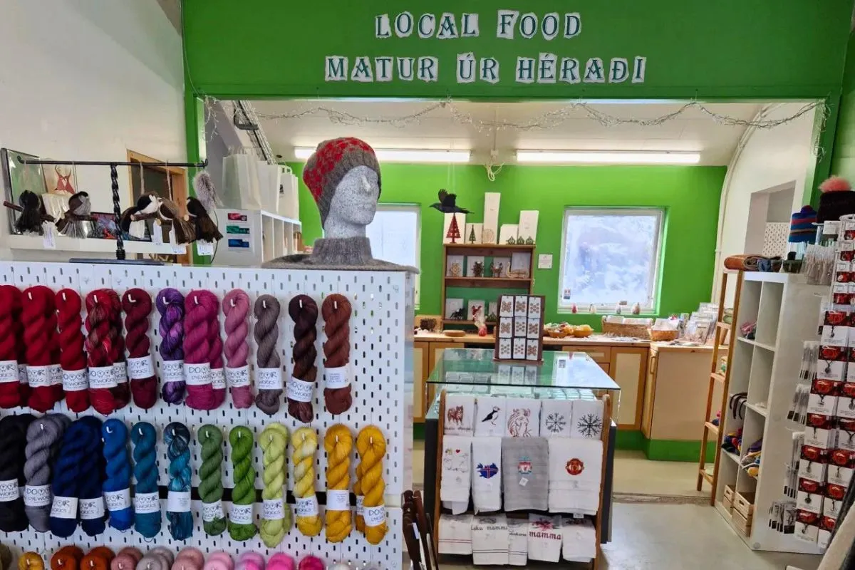 Colorful yarn skeins and local crafts on display inside Ljómalind Local Market.