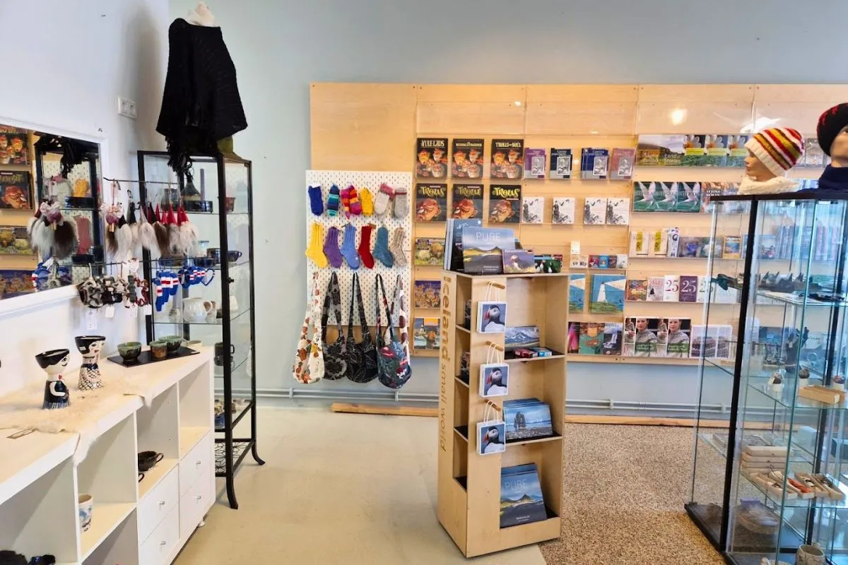 Handmade souvenirs, postcards, and local books arranged on shelves at Ljómalind Local Market.