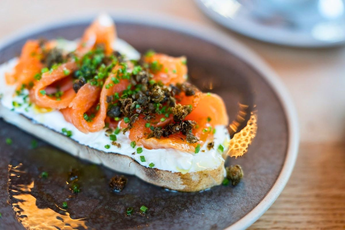 Smoked salmon toast with cream cheese, capers, and fresh chives served at LYST café.