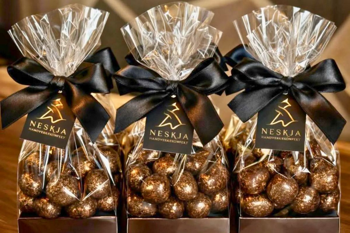 Neskja - Chocolate Confectionery clear gift bags filled with shimmering bronze-dusted chocolate truffles.