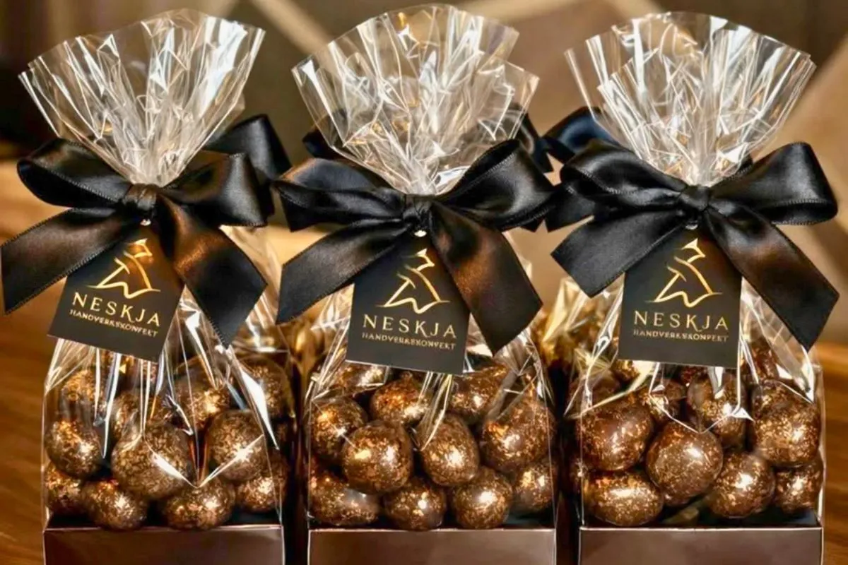 Neskja - Chocolate Confectionery clear gift bags filled with shimmering bronze-dusted chocolate truffles.