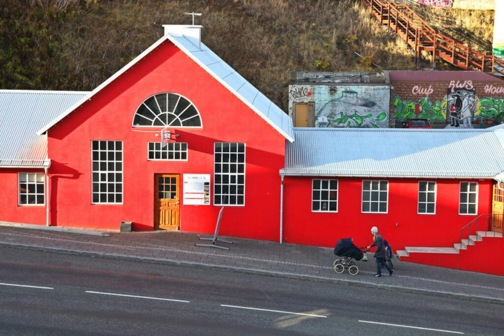 Exterior view of the bright red Rub23 restaurant building in Akureyri, Iceland.