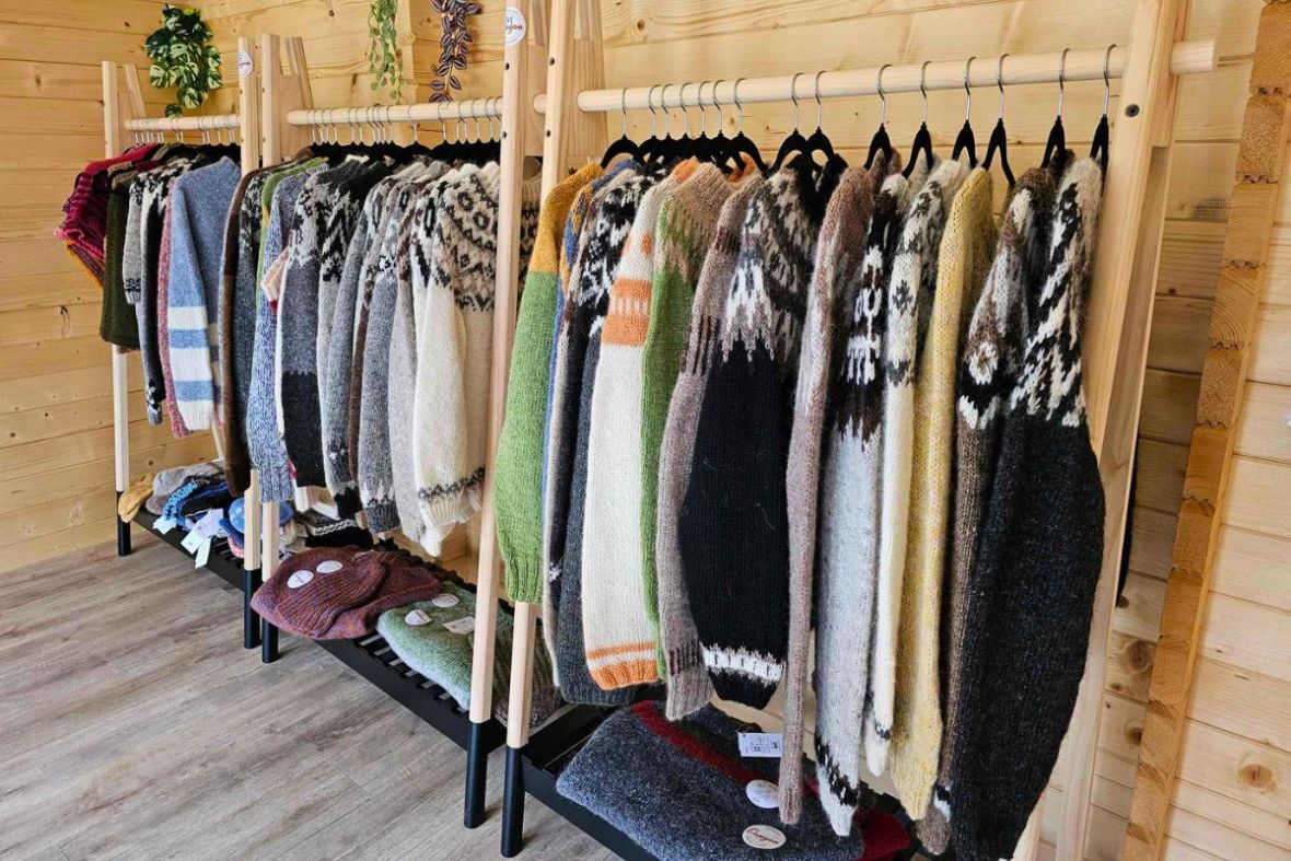 Racks of authentic knitted Icelandic wool sweaters, known as Lopapeysa, inside Stuðlagil shop.