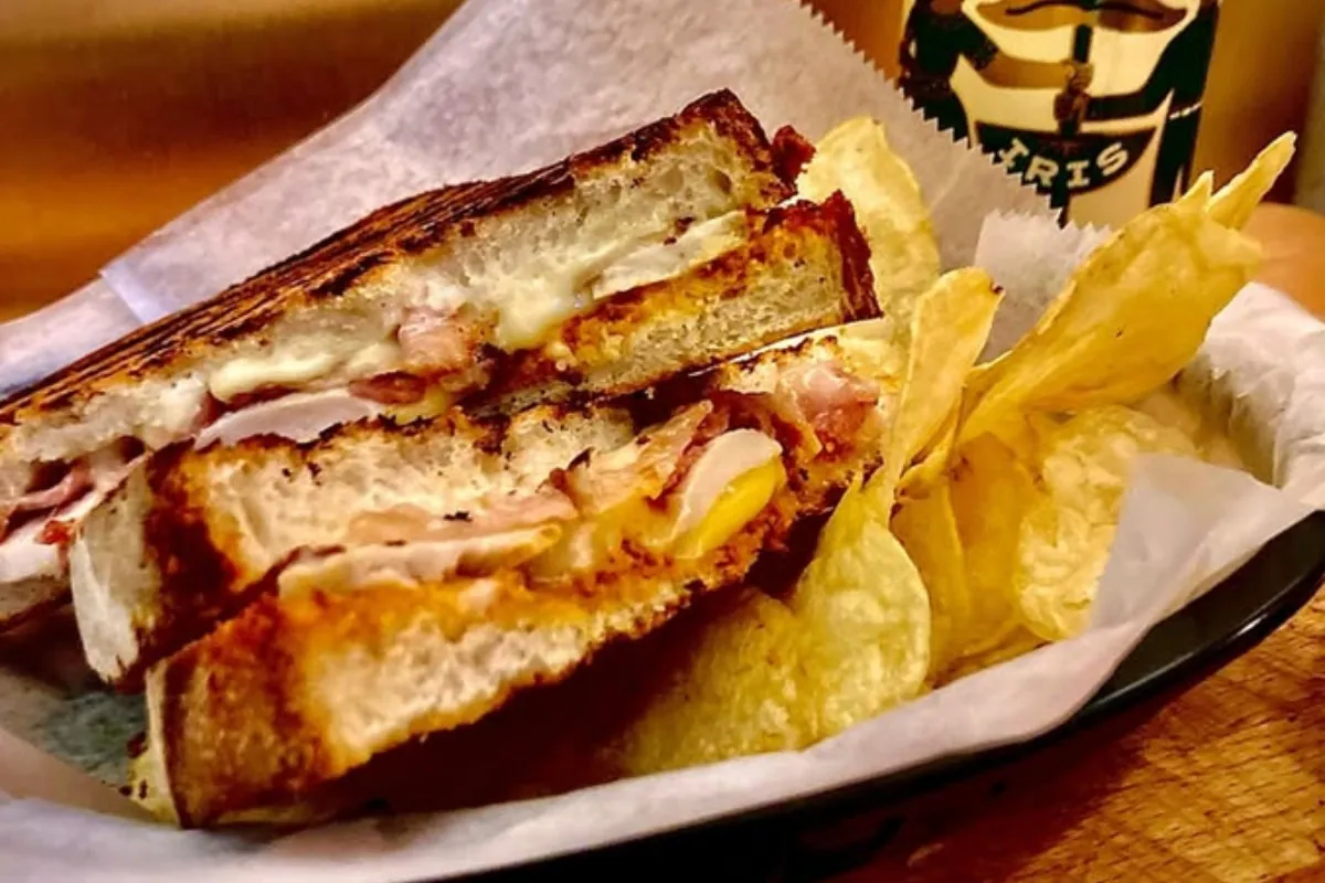 Grilled cheese sandwich with pickles, chips and dipping sauce