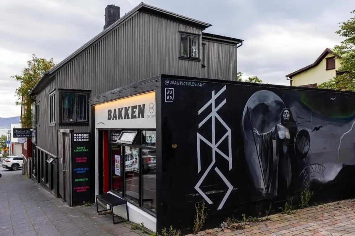 Bakken RVK storefront with a large black wall mural in Reykjavík, recommended by Handpicked Iceland