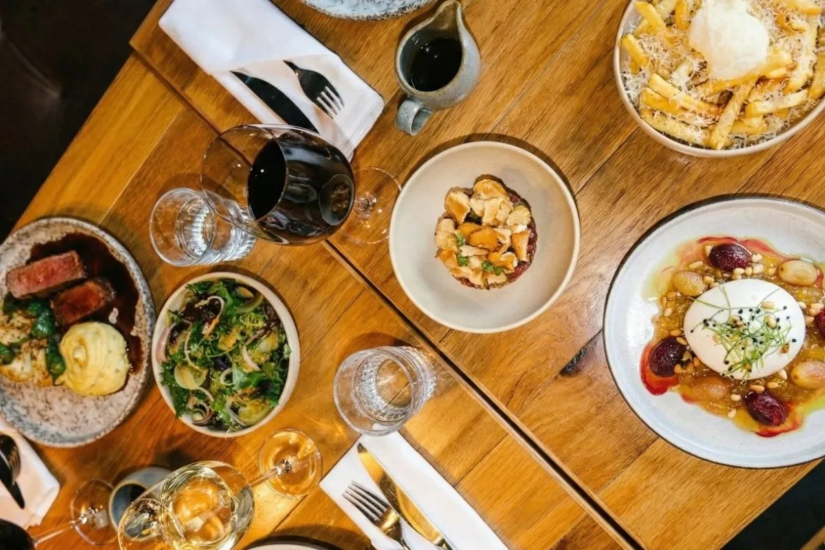 Steak, burrata, fries and wine on a table at Geiri Smart Restaurant in Reykjavik