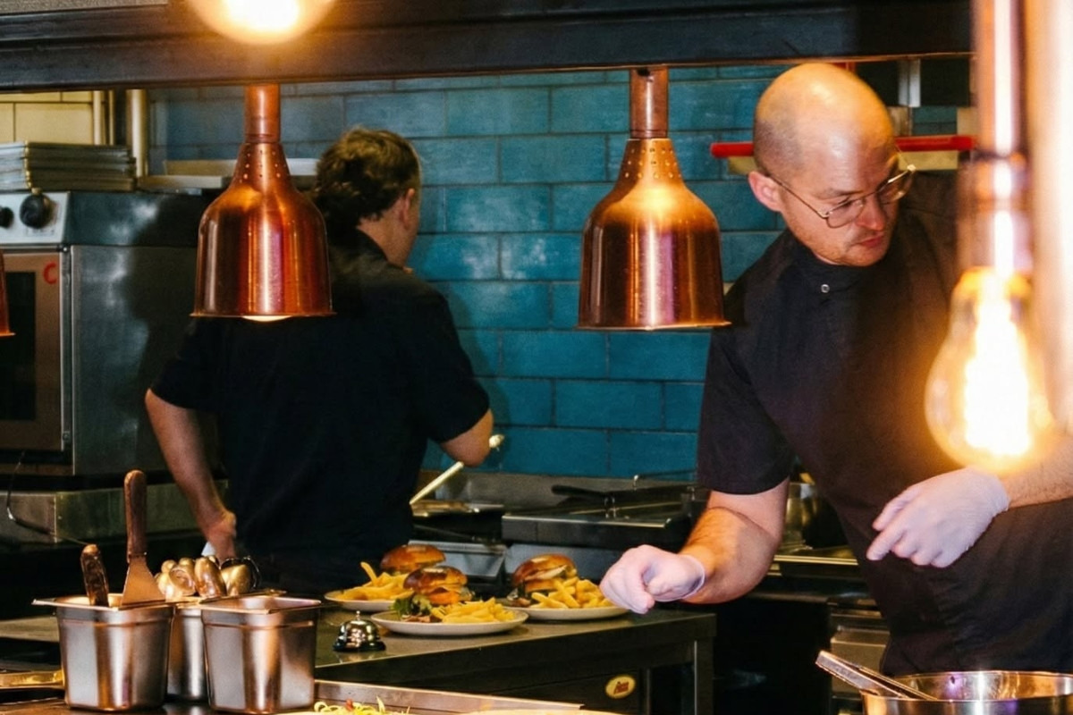 Chefs preparing burgers and fries in the open kitchen at Geiri Smart Restaurant