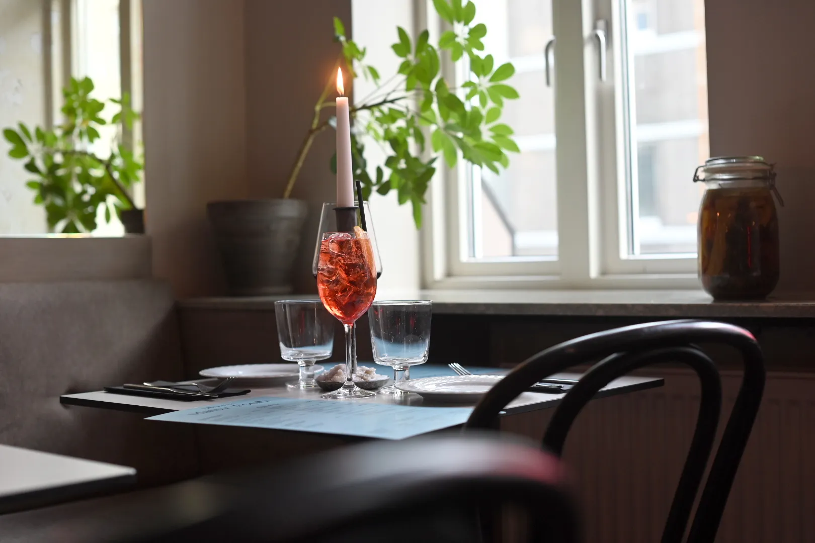 Red cocktail by a candlelit window at Litli Barinn in Reykjavík