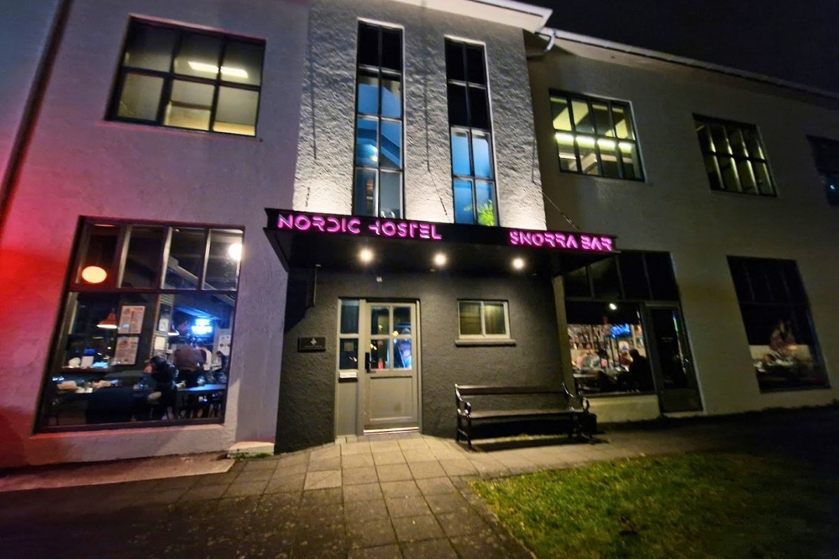 Nordic Hostel and Snorrabar entrance illuminated at night